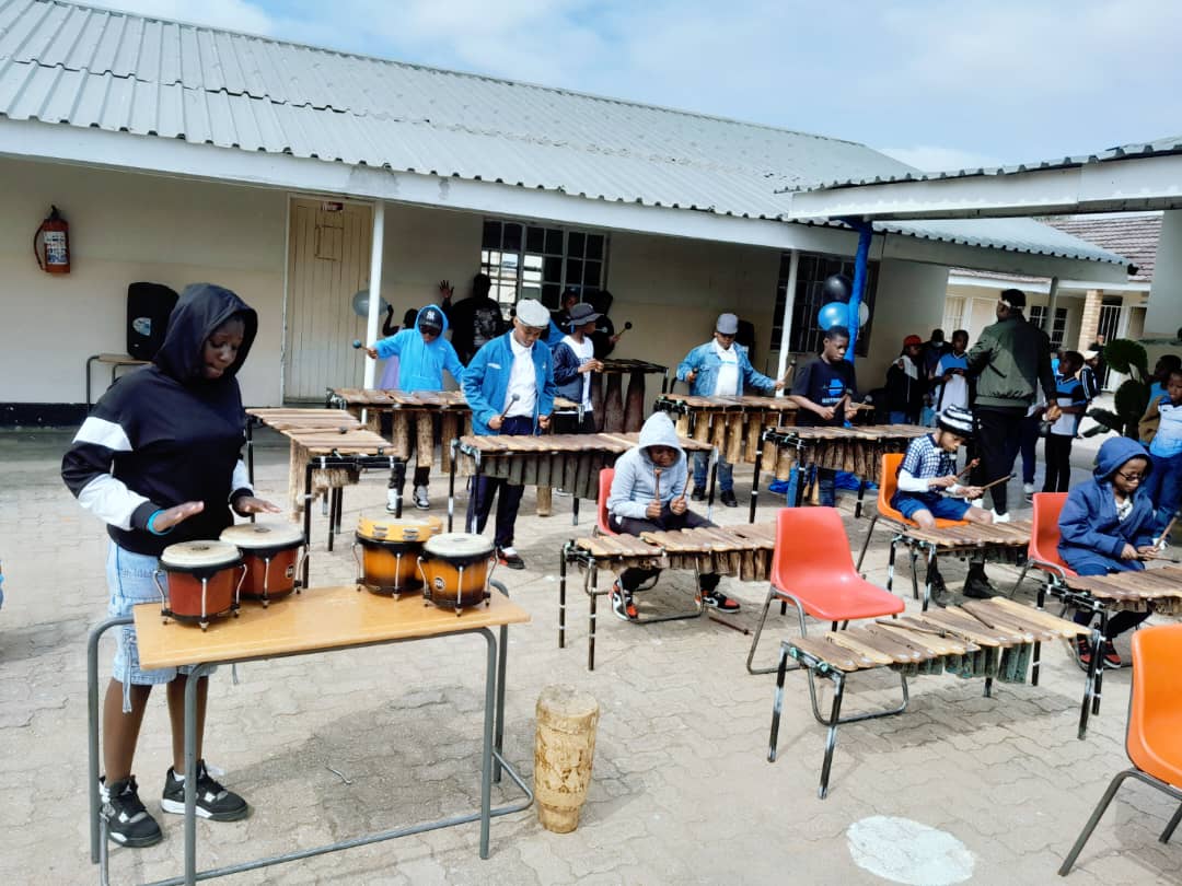 Highridge students performing on marimbas and drums at a school event
